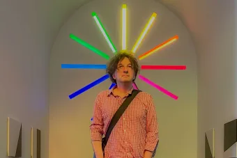 Vladimir Rannev standing in front of mondern art