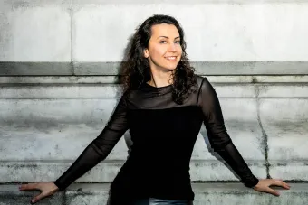 Anna Petrova standing in front of a building