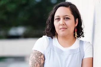  Mercedes Ale Payan Ramirez leaning against a wall