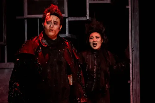 Two ghosts bathed in red light, plot together. 