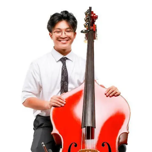 a headshot of Darrin Luong, posing with this bass. 