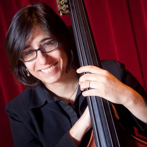 A headshot of Laura Camacho with her double bass