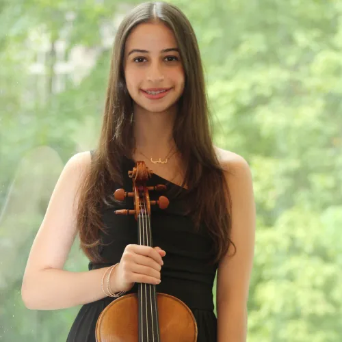 headshot of lilya aljarrah holding her viola