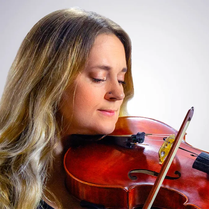 a headshot of Hollie Dzierzanowski with her violin
