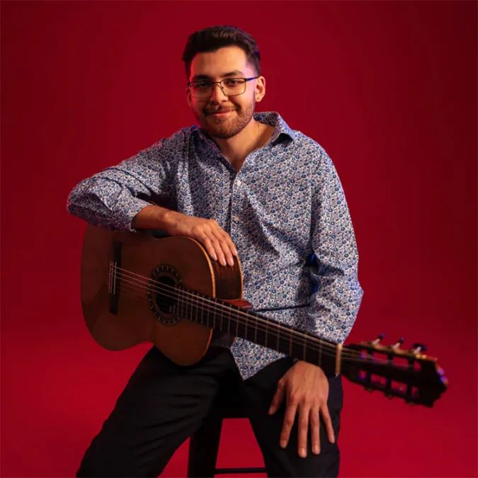 a headshot of David Salugero with his guitar