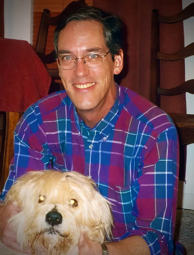 Gregory Allen poses with a dog in a casual, friendly photo