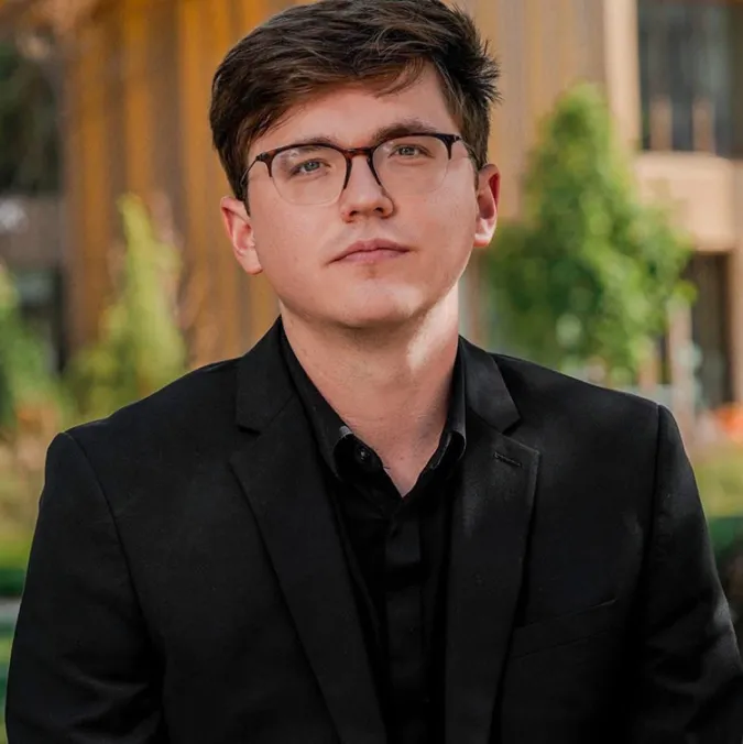 A headshot of Alec Rodriquez