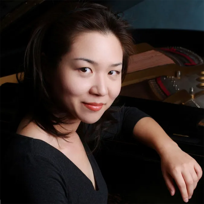 a headshot of Hyun Kim at the piano
