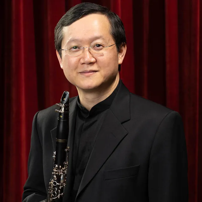 A headshot of Nophachai Cholthitchanta with his clarinet.