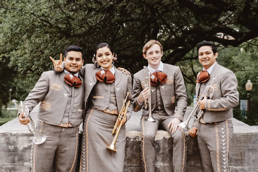 Mariachi Trumpet players showing hook 'em horns
