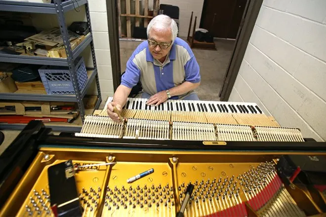 Charles Ball tuning a piano