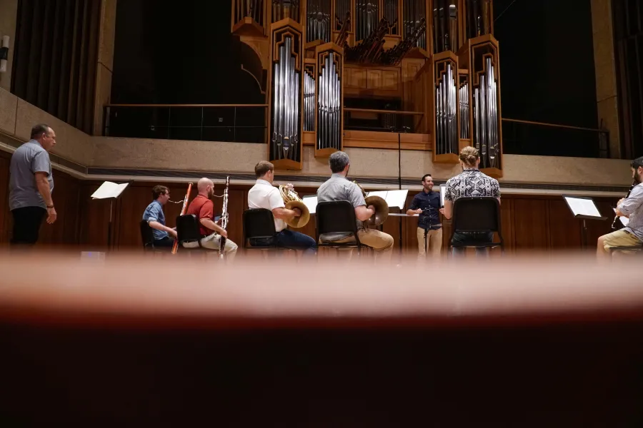 Ensemble plays in front of conductor