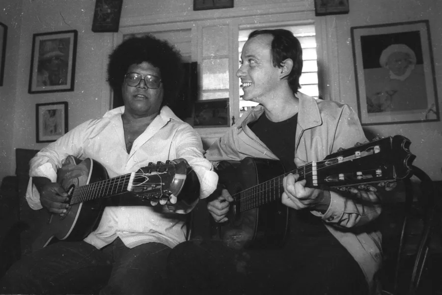 Two men playing guitars 