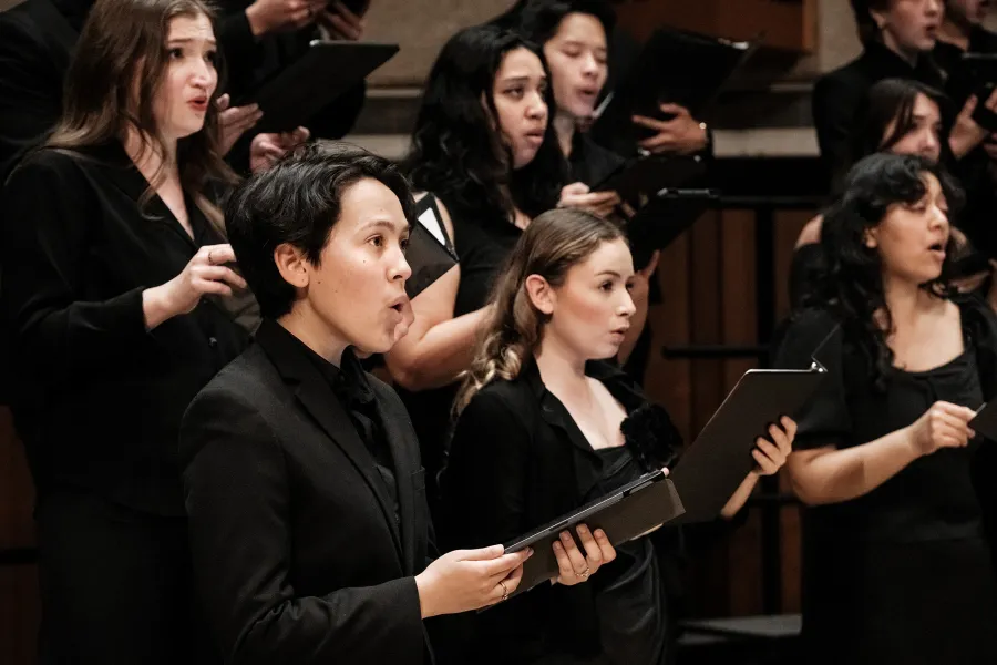 The soprano section of UT Concert Chorale singing in concert.