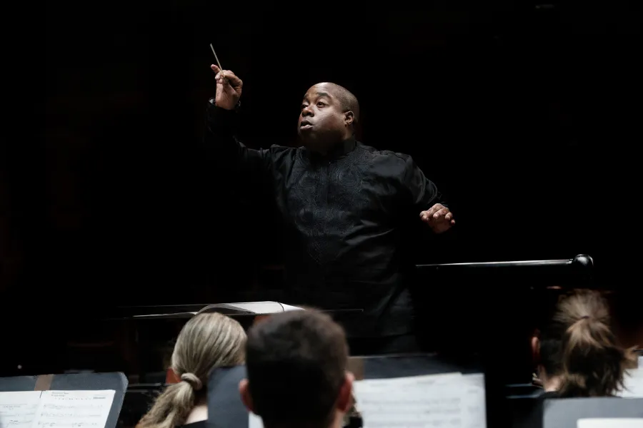 Clifford Croomes conducts from the podium in Bates Recital Hall