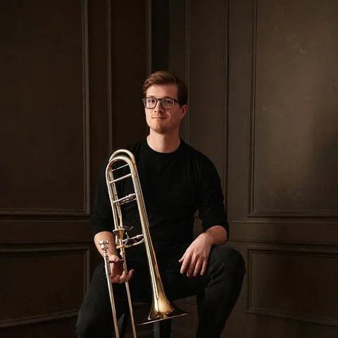 Evan Williams posing with a trombone