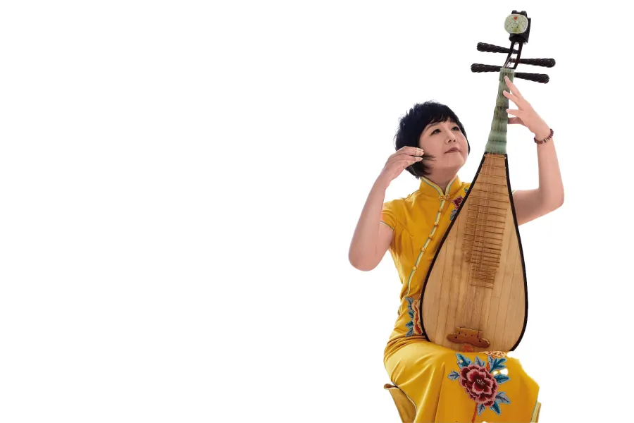 Gao Hong wearing a yellow dress playing her pipa