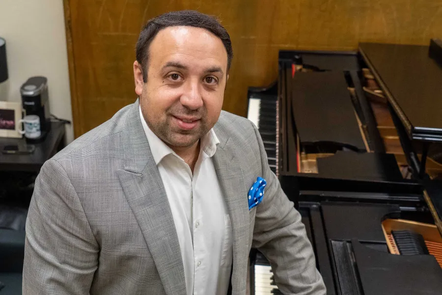 Ross Margitza standing in front of a piano