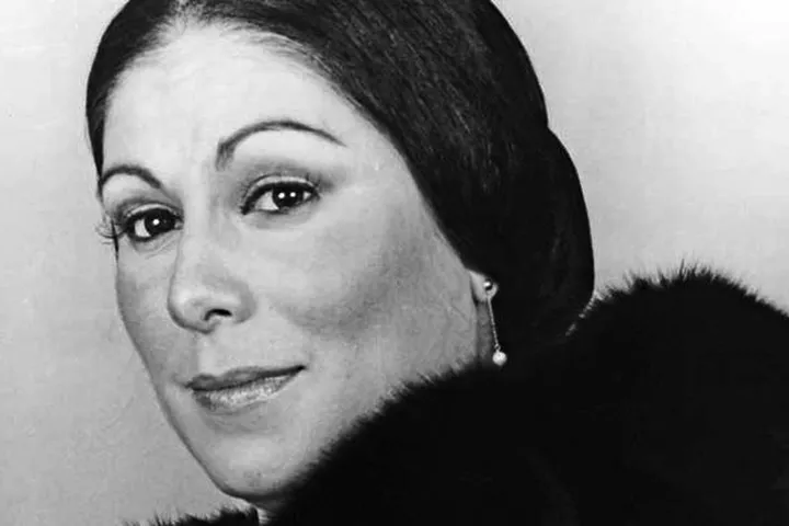 Gilda Cruz Romo looking at the camera with a white background