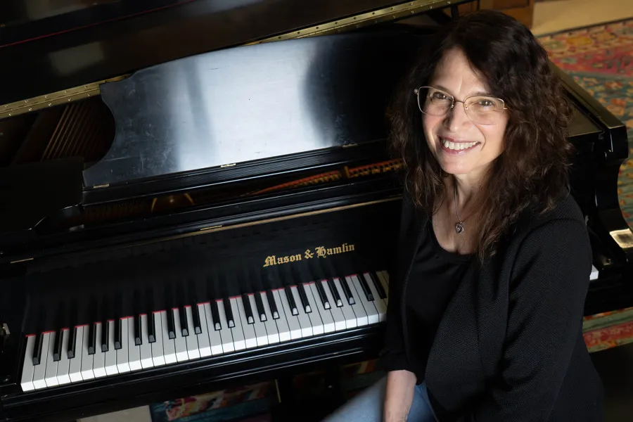 Patti_Wolf_sits in front of a piano