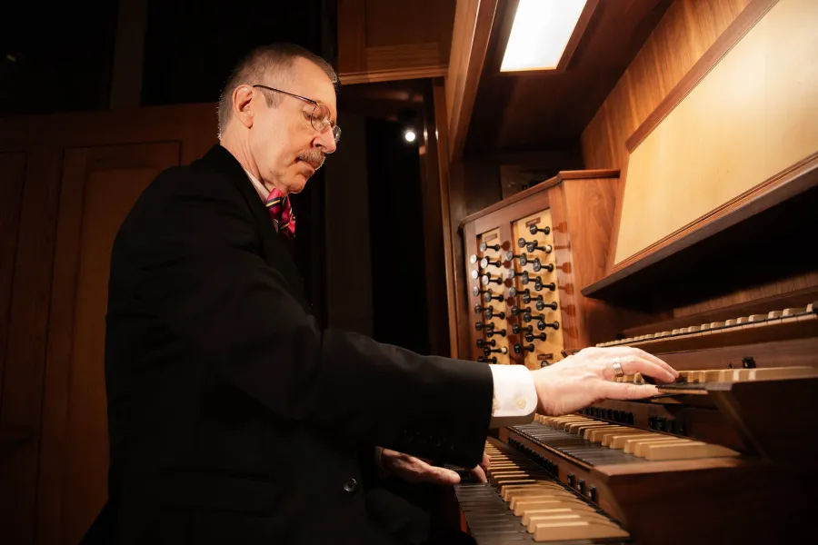 Organist Gregory Eaton, wearing his bowtie, plays the Visser-Rowland organ in Bates Recital Hall.