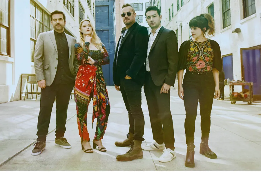 Members of Sybarite 5 casually posing on a street.
