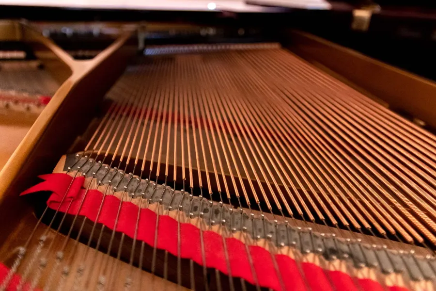 a closeup image of the inside of a piano
